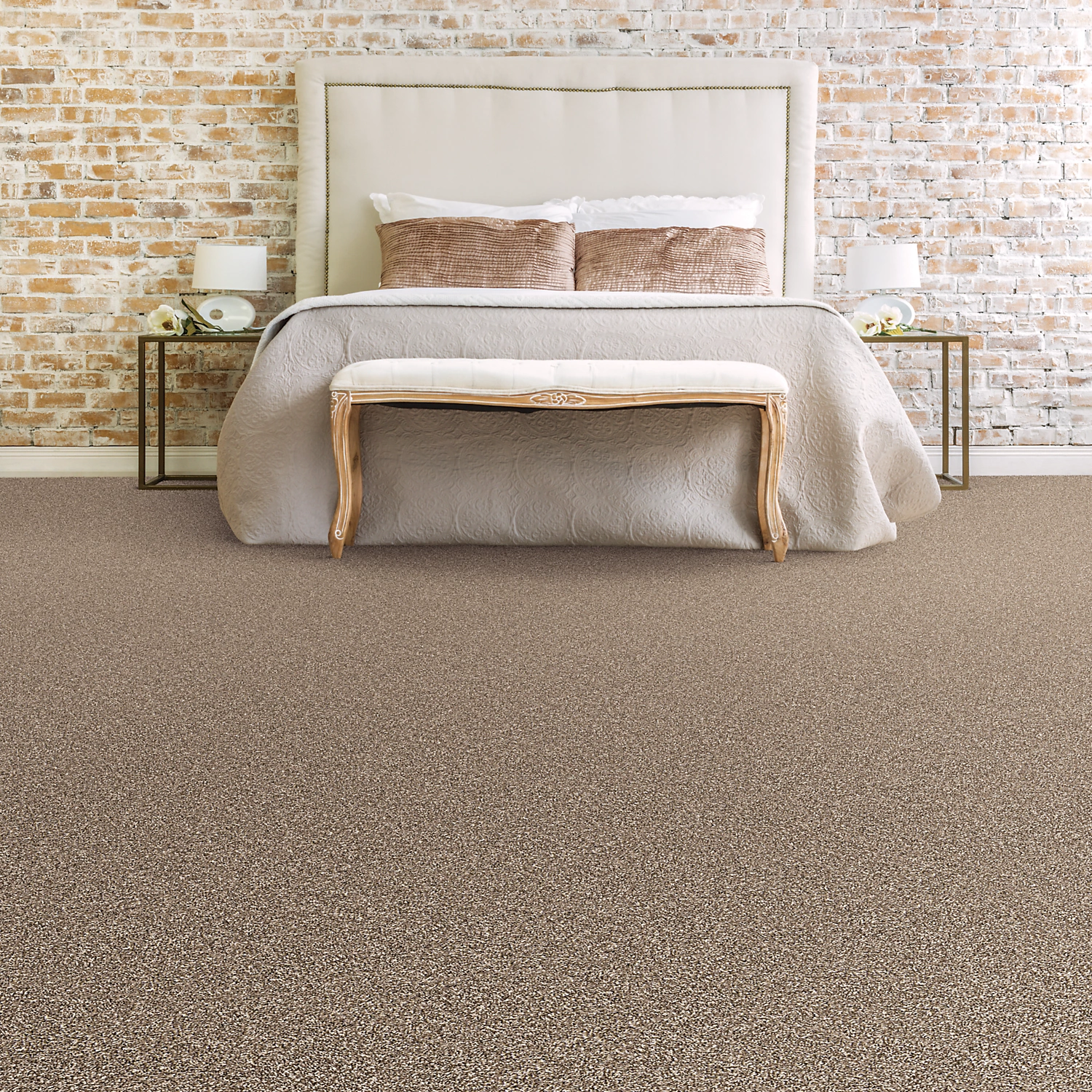 Mohawk EverStrand Dynamic Quality carpet in a bedroom with a whitewashed brick wall, a general room view of the collection sold direct at Kwest Flooring in San Diego